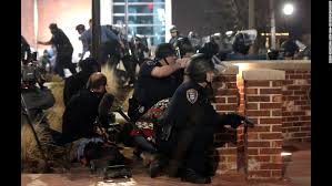 Grand Jury Announcment police watching crowd inthe street